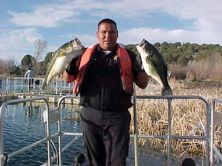 Game Ranger Stanley with two Seneca Lake largemouth bass caught during fish survey in 2003.